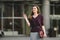 Business woman standing on street against office building. City business woman working. Portrait business woman smiling