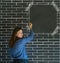 Business woman, student or teacher on brick wall notice board