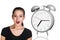 Business woman surprised big gray alarm clock