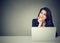 Business woman thinking daydreaming sitting at desk with laptop computer