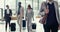 Business woman, travel and corporate staff walking in a airport lobby for work trip. Suitcase, company people at a