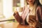 Business woman typing text message on smart phone in a cafe, Close up of female hands holding cell telephone with screen