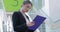 Business woman using mobile phone on stairs at office center