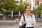 Business woman using speaker phone outdoor