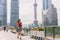 Business woman walking using phone commuting to work in Shanghai city, China. Tourist travel lifestyle Asian lady city