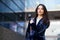 Business woman wearing blue suit outside an office building.