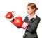 Business woman wearing boxing gloves punching isolated