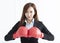 Business woman wearing boxing gloves ready to fight