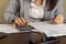 A business woman wearing formal dress is working at an office setting.