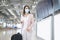A business woman is wearing protective mask in International airport, travel under Covid-19 pandemic, safety travels, social