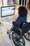 Business woman, wheelchair and disability of a database administrator working on a computer. Office, disabled employee