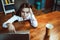 Business woman working laptop computer drinking coffee through straw. Busy young woman works at office workplace. Crisis