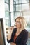 Business woman working, thinking and brainstorming alone on a white board for a meeting. Office employee working on