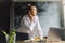 Business woman works in front of laptop, business analyst at work. A beautiful girl in white shirt stands near table