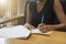 Business women signing contract document form on desk.