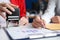 Business women signing document and certifying seal closeup