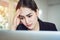 Business women sit and strain the computer screen for a long time. Because the work has been overloaded.