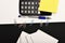 Business and work concept. Office tools on black and white background. Stationery and calculator, top view. Yellow note