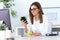 Business young woman using her mobile phone in the office.