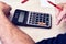 Businessman or accountant uses a calculator for financial tax or budget analysis