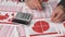 Businessman accountant using calculator for calculating finance on desk office. Business financial accounting concept. Red reports