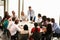 Businessman Addressing Meeting Around Boardroom Table