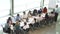 Businessman Addressing Meeting Around Boardroom Table