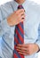 Businessman Adjusting Necktie