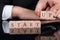 Businessman arranging startup blocks on desk