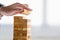 Businessman arranging wood block and stacking as tower by hand. Business organization and company growth progress. Success of