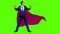 Businessman as a superhero standing against green screen