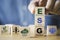 Businessman assemble ESG wording on wooden cube block for sustainable organization development and corporation of Environment