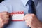 Businessman Attaching Name Tag At Conference