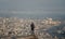 Businessman with backpack standing on summit looking city view with air pollution environment