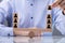 Businessman Balancing Blocks Over The Seesaw