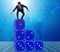 Businessman balancing on top of dice stack in uncertainty concep