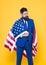 Businessman bearded man in formal suit hold flag USA. Businessman concept. Successful businessman lawyer or politician