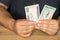 Businessman behind the desk holds 200 and 500 Honduran Lempiras banknotes in his hand, Honduras money, Banking investment