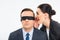 Businessman in blindfold and businesswoman