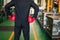 Businessman with boxing gloves in factory