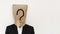 Businessman with brown paper bag on head, with question mark symbol with copy space, on white background