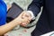 Businessman and business lady shake hands. The male in a suit and a white shirt.