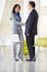 Businessman And Businesswoman Shaking Hands In Modern Office