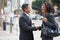 Businessman And Businesswoman Shaking Hands In Street
