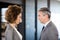 Businessman and businesswoman standing face to face