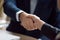 Businessman and businesswoman in suits handshaking showing partner respect, closeup