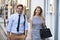 Businessman And Businesswoman Walk to Work Through City Street