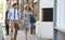 Businessman And Businesswoman Walk to Work Through City Street