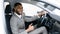 Businessman Buying Car Gesturing Thumbs-Up In Driver`s Seat In Showroom