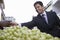 Businessman Buying Grapes In Market